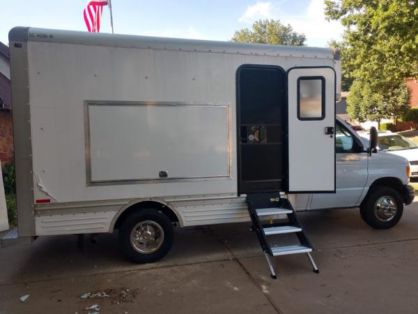 outreach truck before wrap, door with screen door stairs can stay down with door open or closed, very solid stairs, we have a 100 amp solar panel for lighting on the roof, and AC/Heater on the roof
